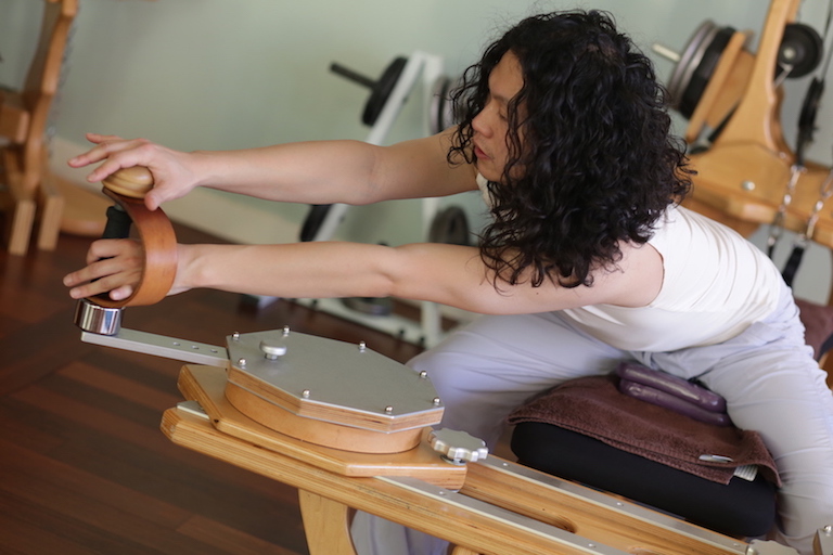 Joseph Liu Gyrotonic Trainer Joseph Liu exericising on the Gyrotonic Handles